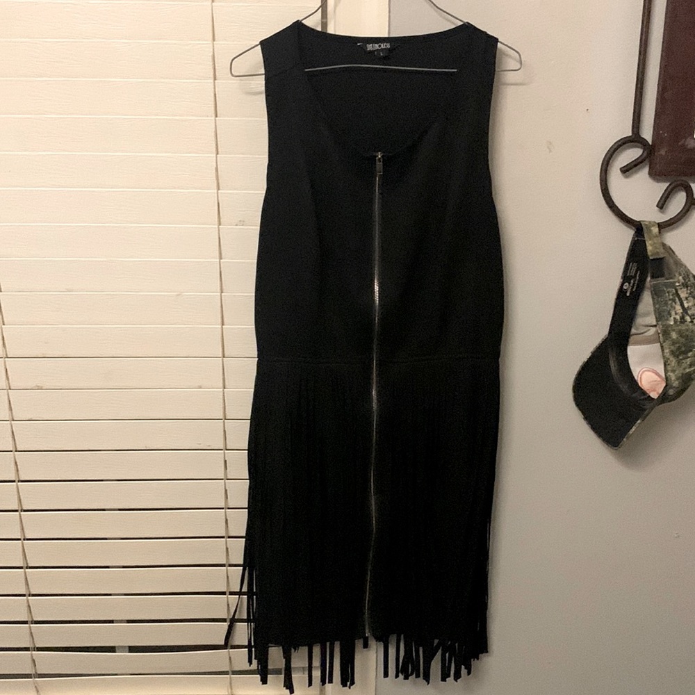 This is a black dress zips in front with fringe all the way around.